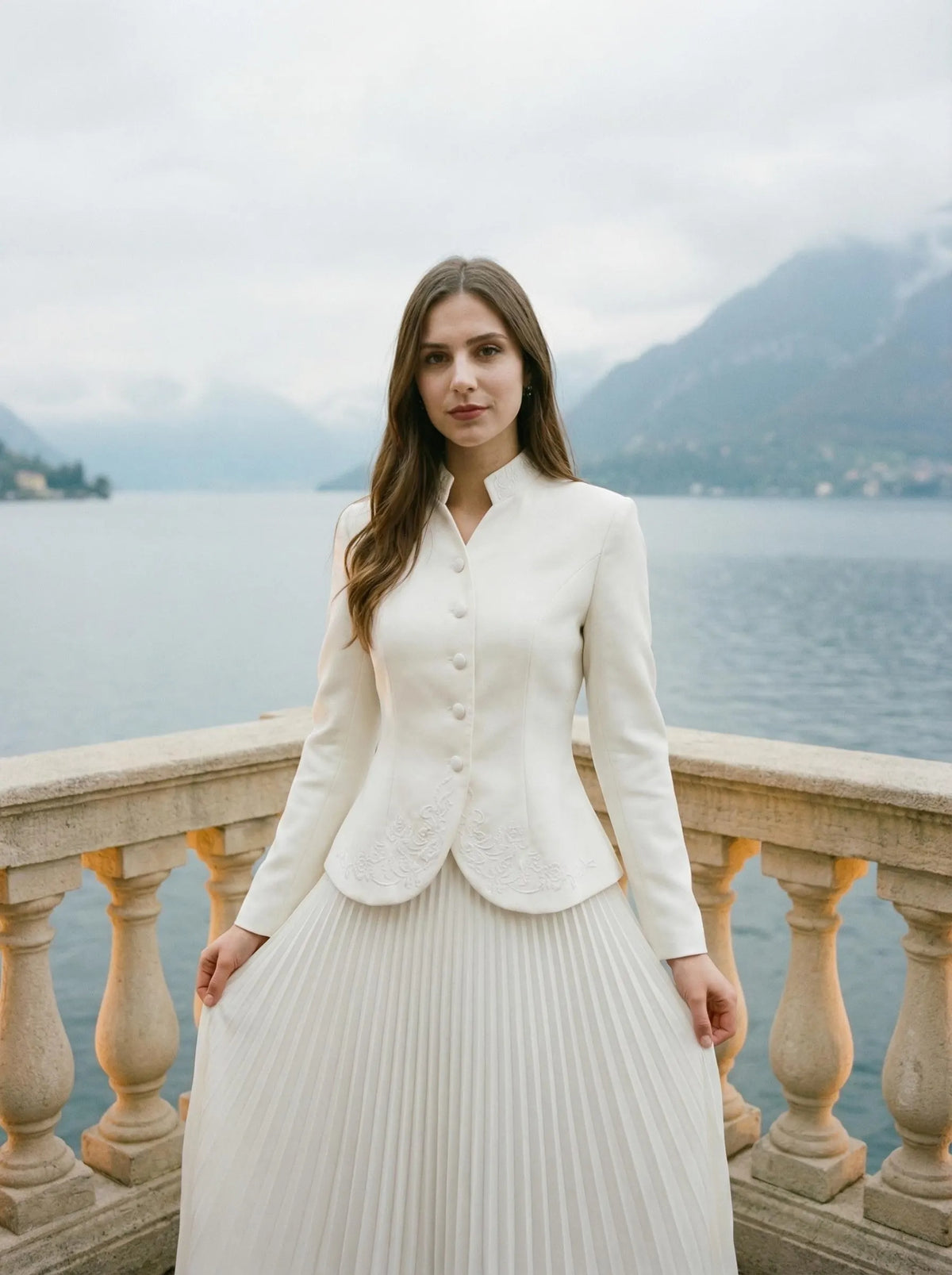 A two-piece set: a fitted peplum blazer worn over a pleated maxi skirt.