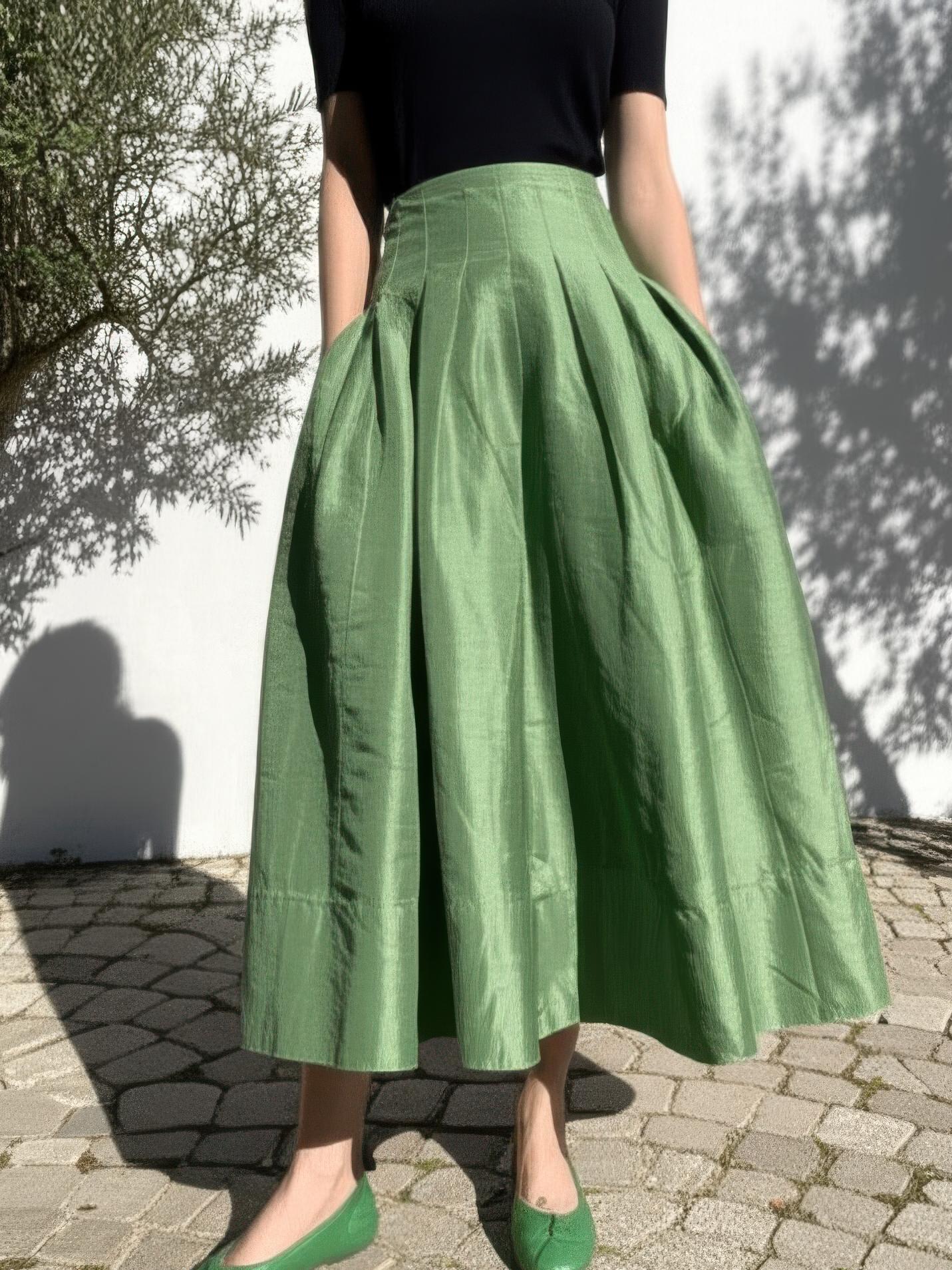 Saraura's Emerald Green Pleated Midi Skirt, high waisted and A-line, worn with a fitted top.