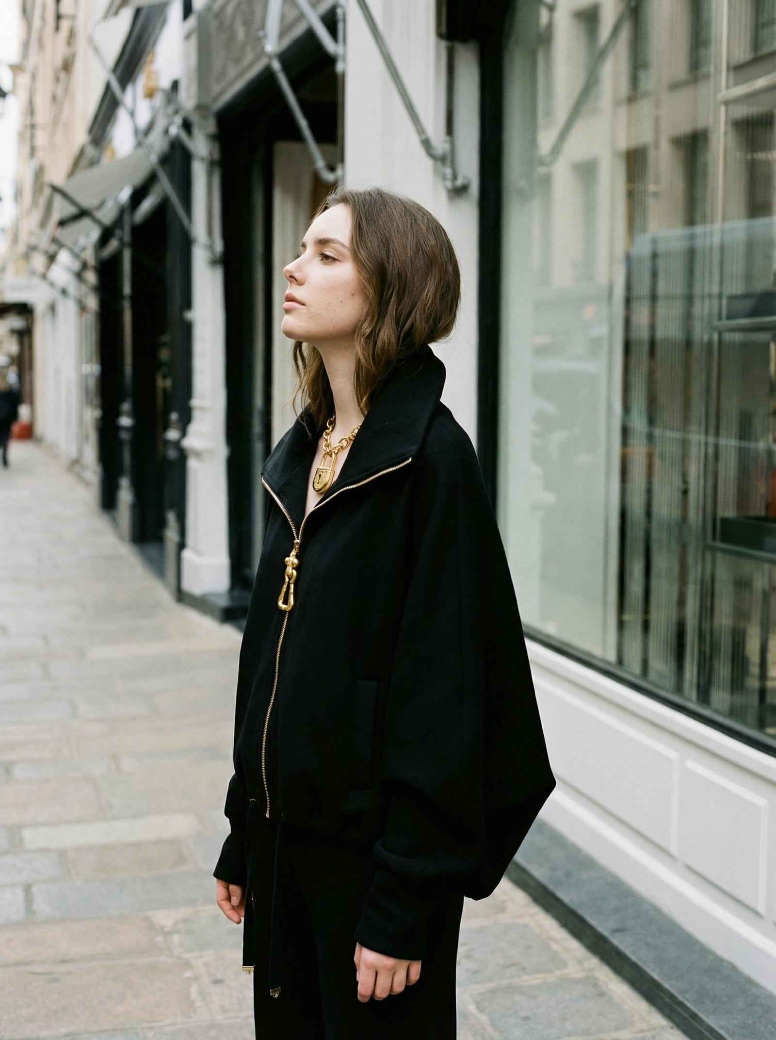 Saraura's Avant Garde Black Jacket worn open, the high collar turned up.
