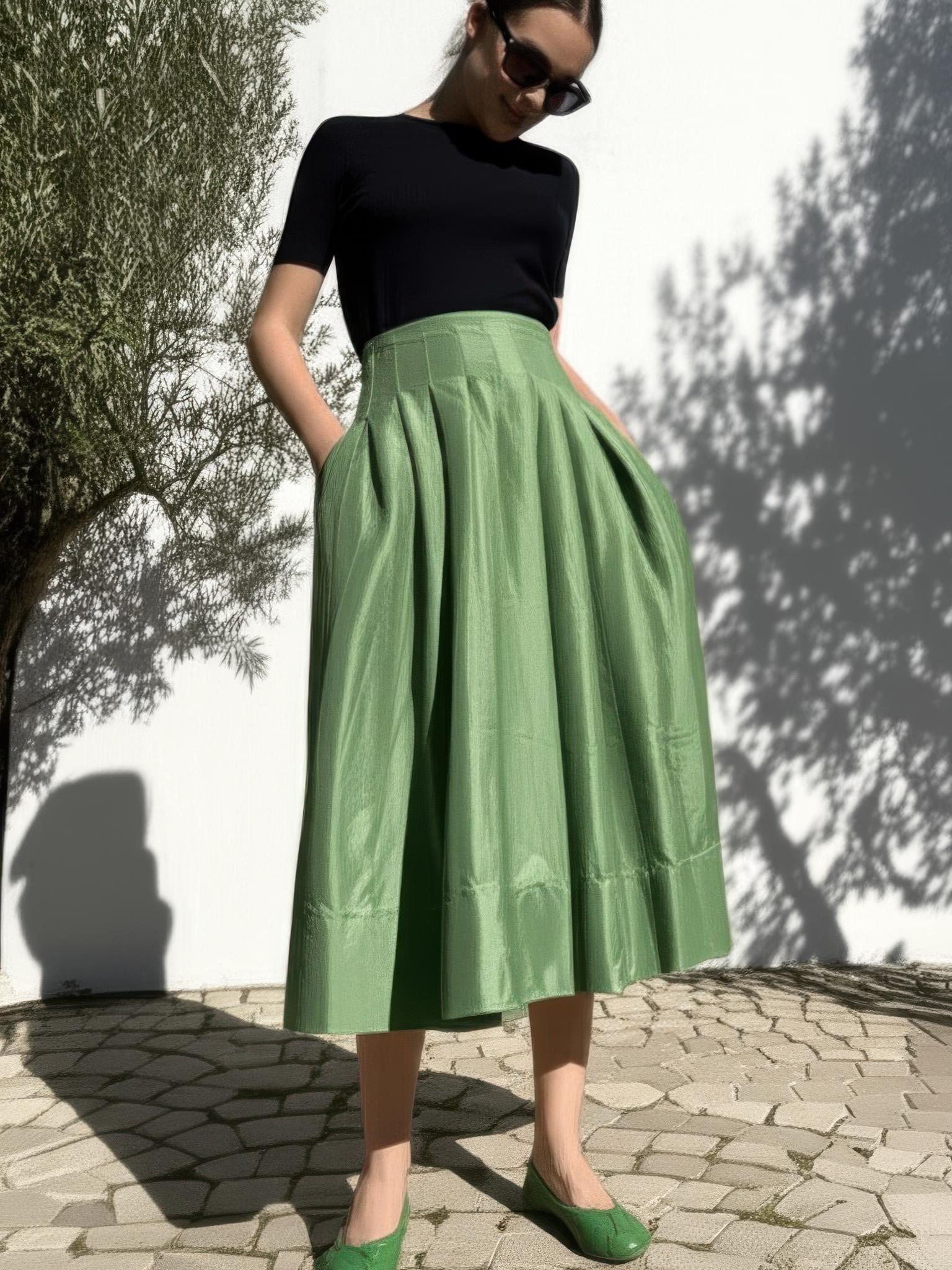 Saraura's Emerald Green Pleated Midi Skirt, the pleats falling from the high waist.